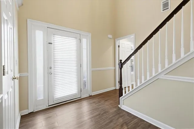 a view of an entryway with wooden floor