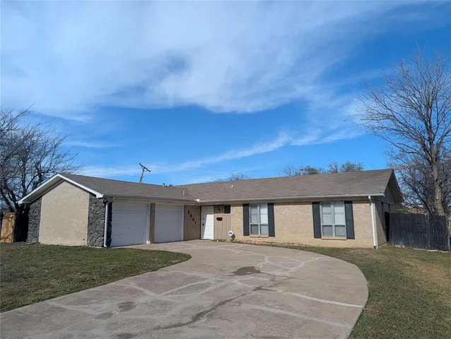 a front view of a house with a garden and trees