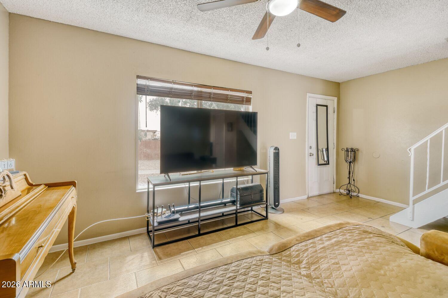 4625 West Thomas Road, Unit 39 Phoenix, AZ 85031 - Photo 5 of 27 a living room with furniture and a flat screen tv
