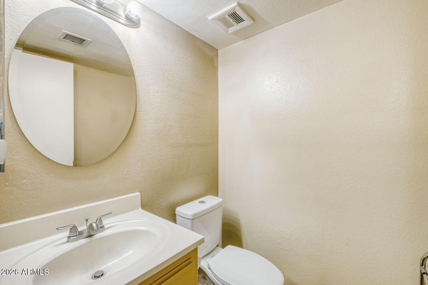 4625 West Thomas Road, Unit 39 Phoenix, AZ 85031 - Photo 7 of 27 a bathroom with a sink mirror and toilet