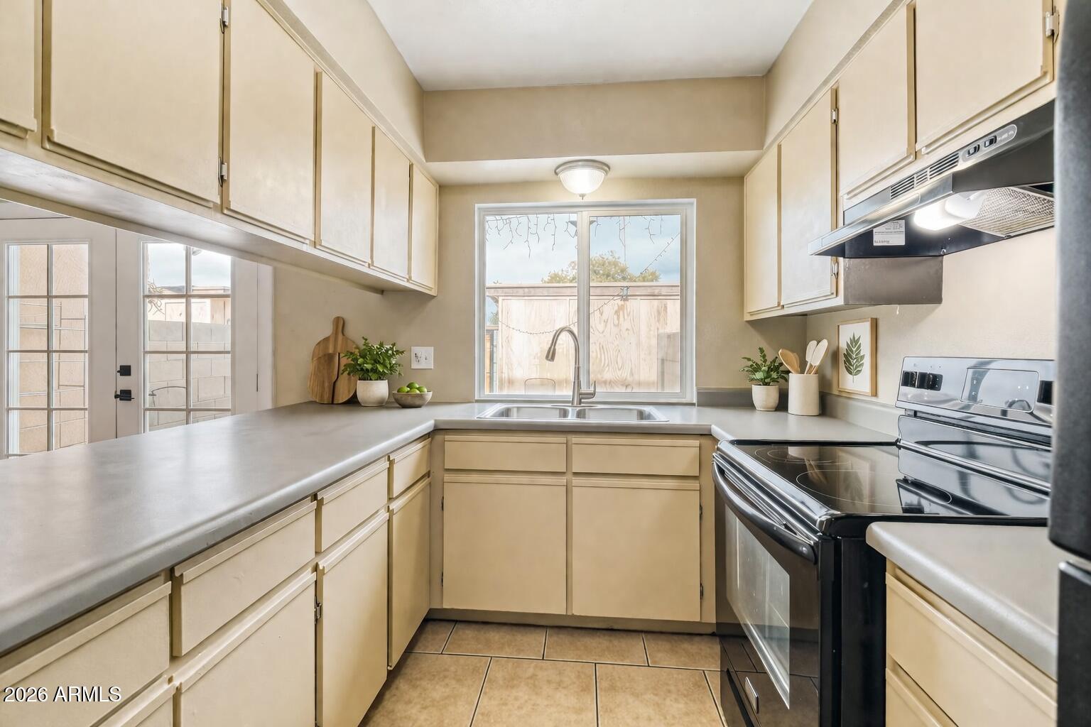 4625 West Thomas Road, Unit 39 Phoenix, AZ 85031 - Photo 10 of 27 a kitchen with a sink stove and cabinets