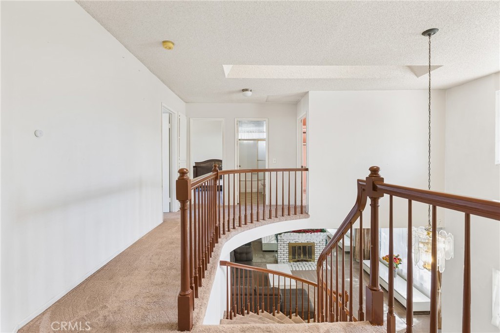 24321 Barley Road Moreno Valley, CA 92557 - Photo 30 of 66 a view of a hallway with wooden floor and stairs