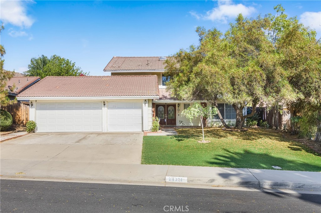 24321 Barley Road Moreno Valley, CA 92557 - Photo 3 of 66 a front view of a house with a yard