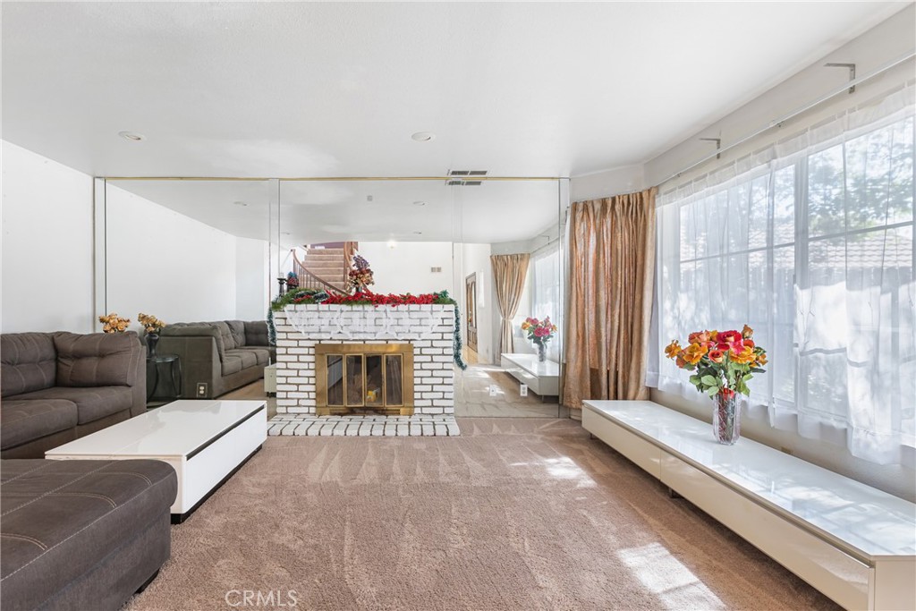 24321 Barley Road Moreno Valley, CA 92557 - Photo 7 of 66 a living room with furniture and a fireplace