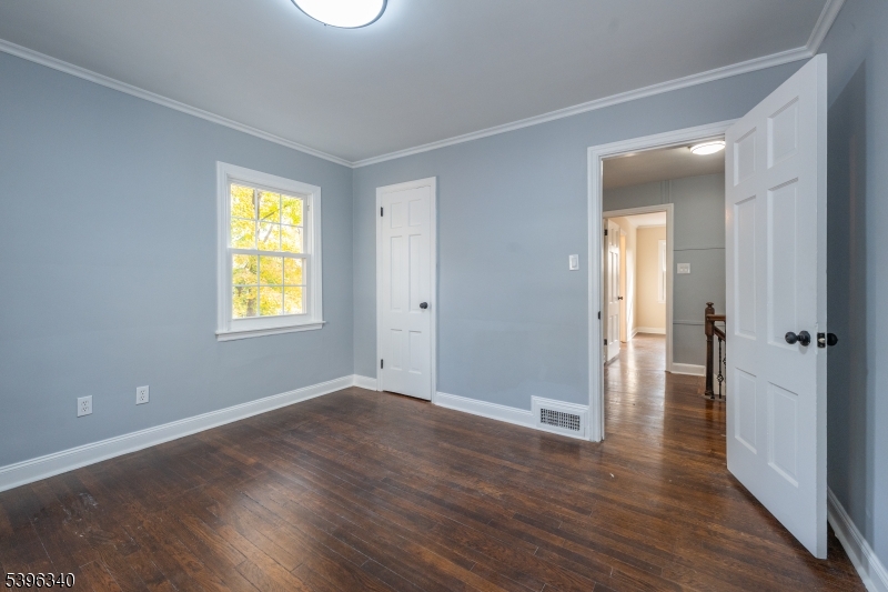 211 Conway Court South Orange, NJ 07079 - Photo 25 of 26 a view of an empty room with wooden floor and a window
