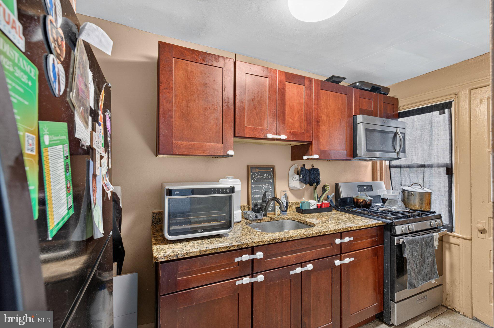 226 West Laveer Street Philadelphia, PA 19120 - Photo 11 of 23 a kitchen with stainless steel appliances granite countertop a refrigerator a stove top oven a sink and dishwasher