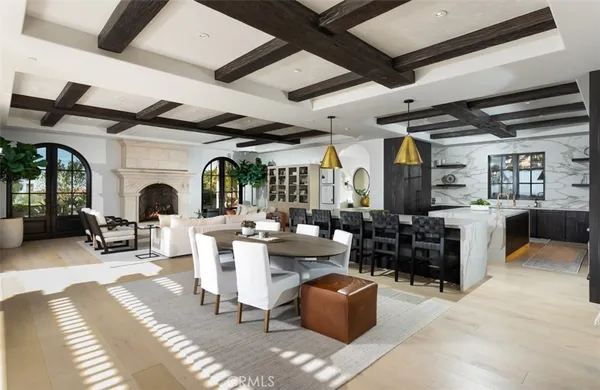 a kitchen with stainless steel appliances granite countertop a kitchen island a stove a dining table and chairs