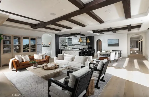 a living room with fireplace furniture and a large window