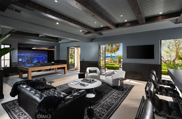 a living room with furniture a chandelier and a dining room