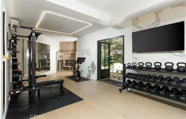 a living room with furniture a chandelier and a flat screen tv