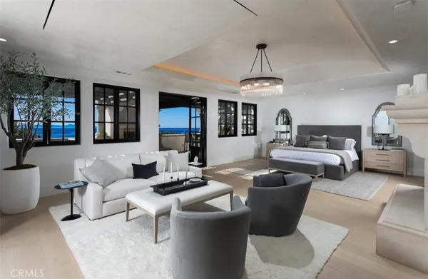a large white kitchen with a large window and stainless steel appliances
