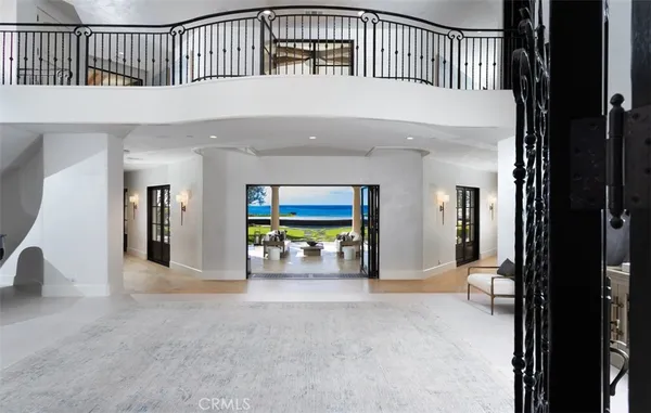 a living room with furniture a floor to ceiling window and a potted plant