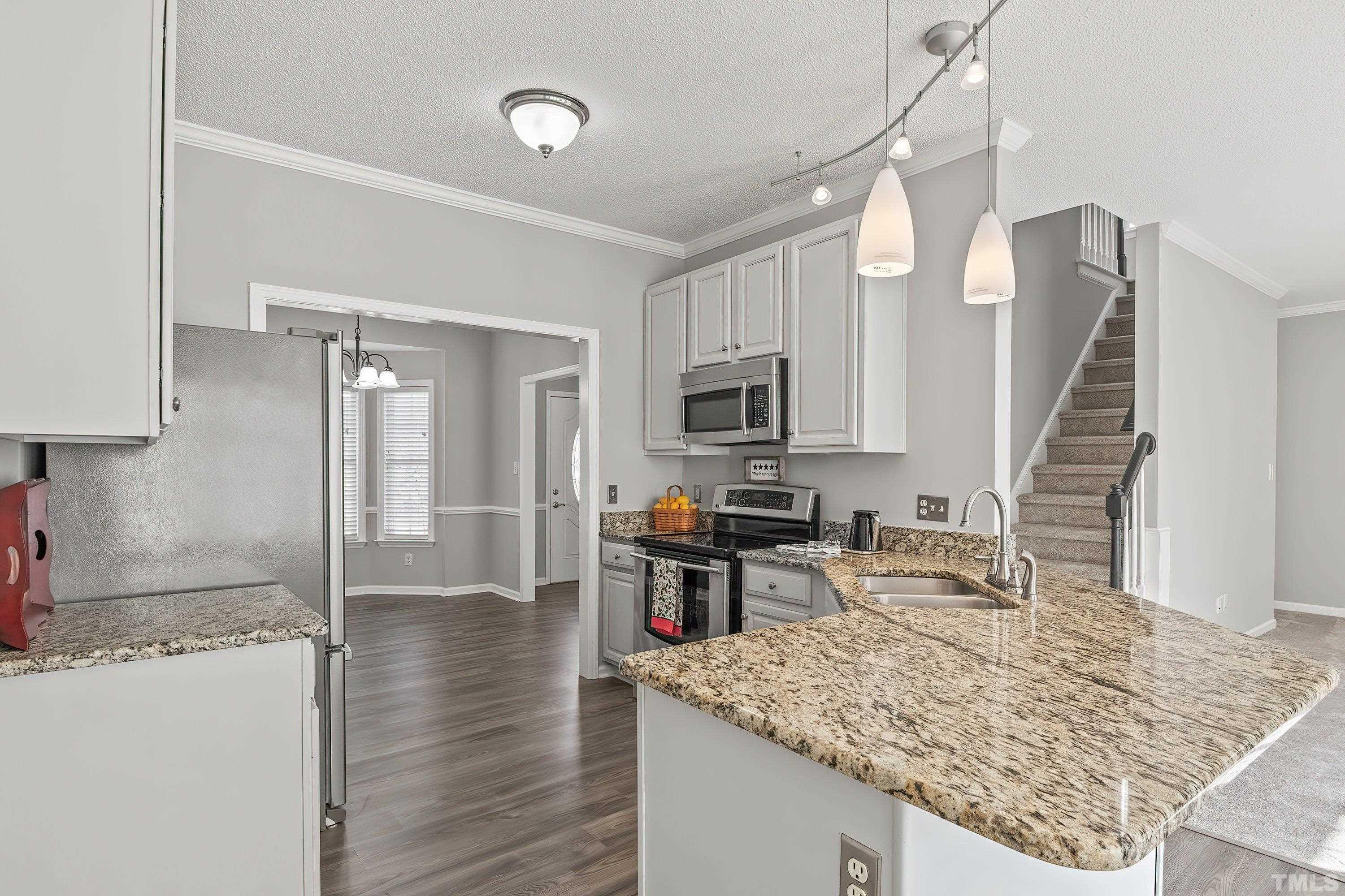 1008 Linden Crest Road Raleigh, NC 27603 - Photo 11 of 37 a kitchen with sink refrigerator and microwave