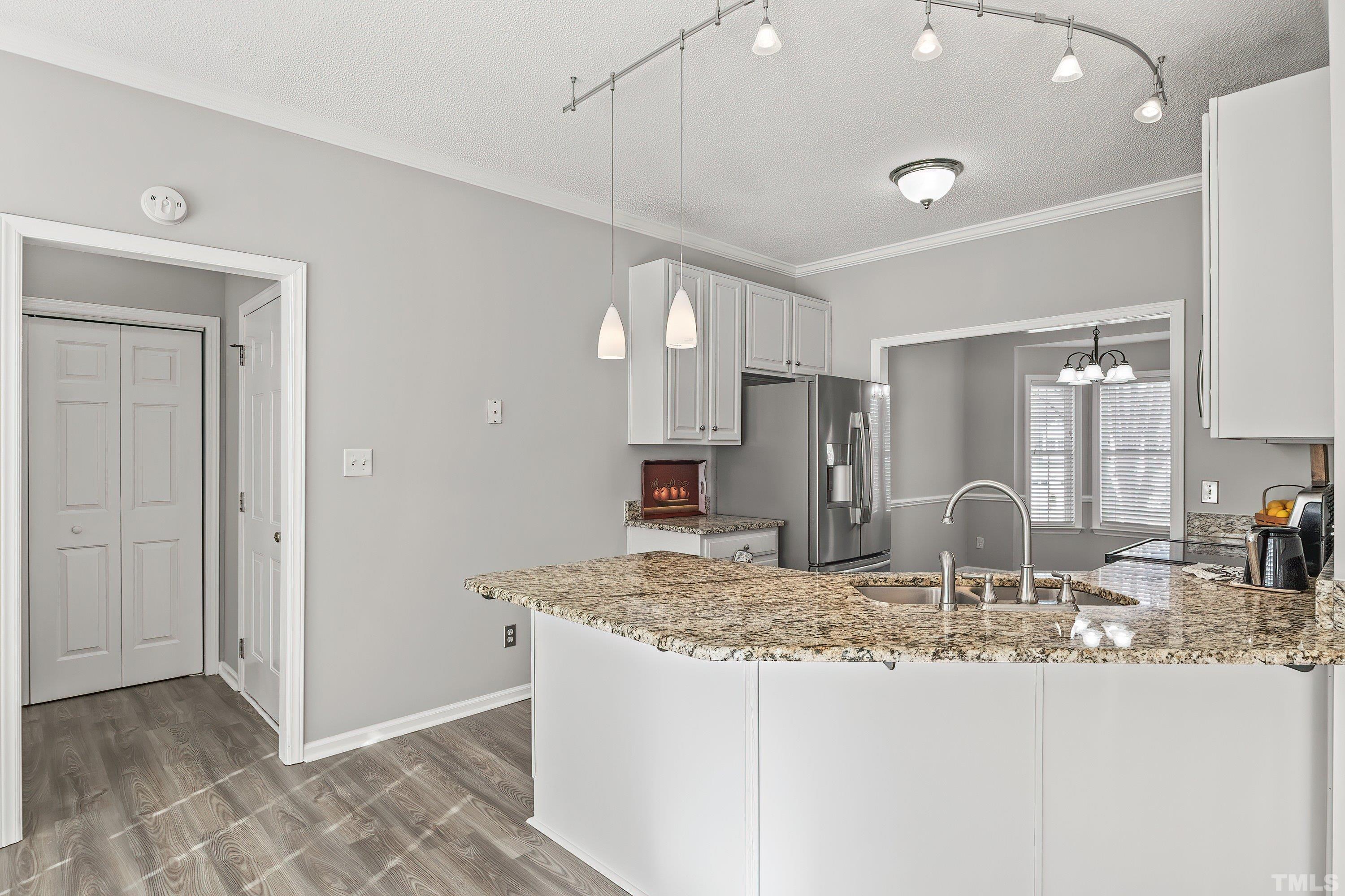 1008 Linden Crest Road Raleigh, NC 27603 - Photo 12 of 37 a view of a kitchen with granite countertop cabinets and refrigerator