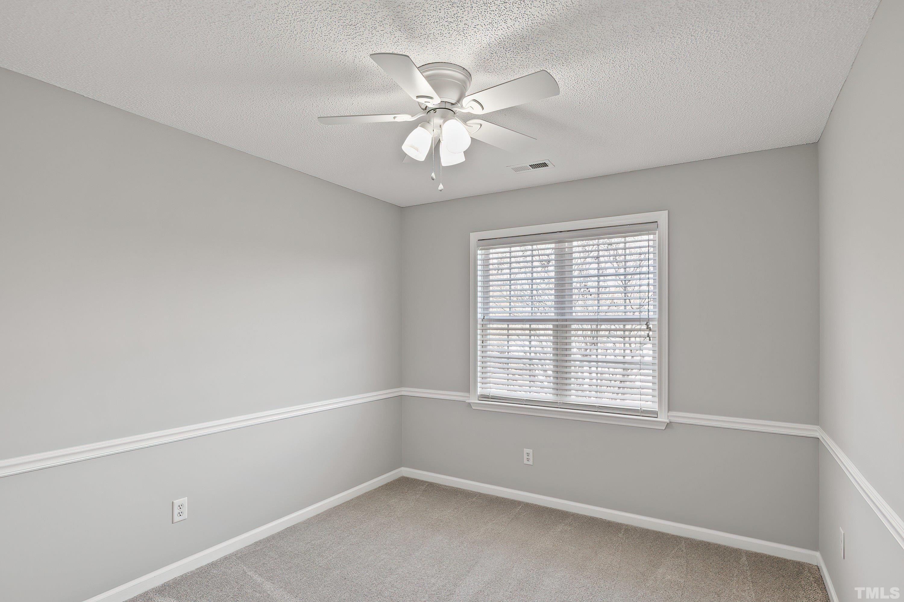1008 Linden Crest Road Raleigh, NC 27603 - Photo 24 of 37 an empty room with a window and a fan