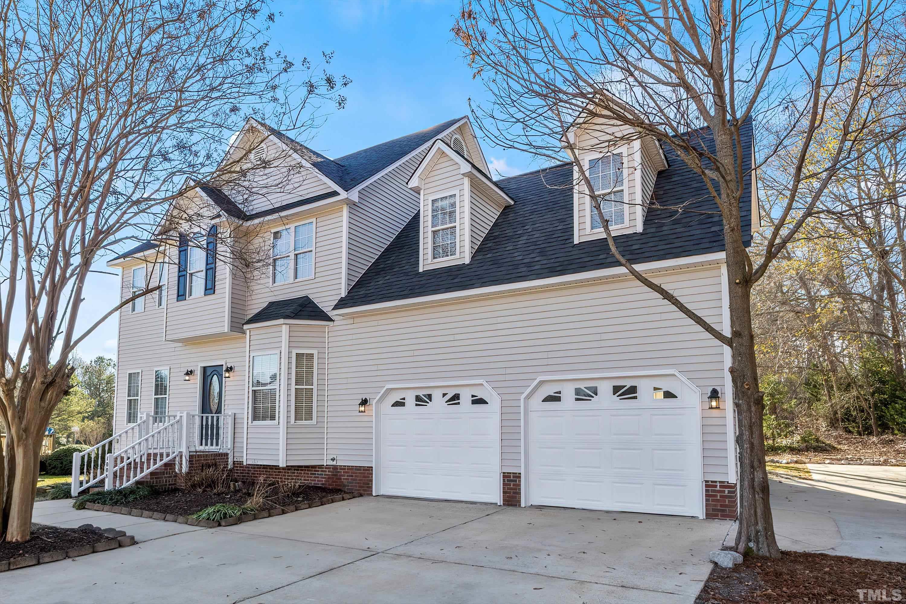 1008 Linden Crest Road Raleigh, NC 27603 - Photo 3 of 37 a view of a white house with a large tree