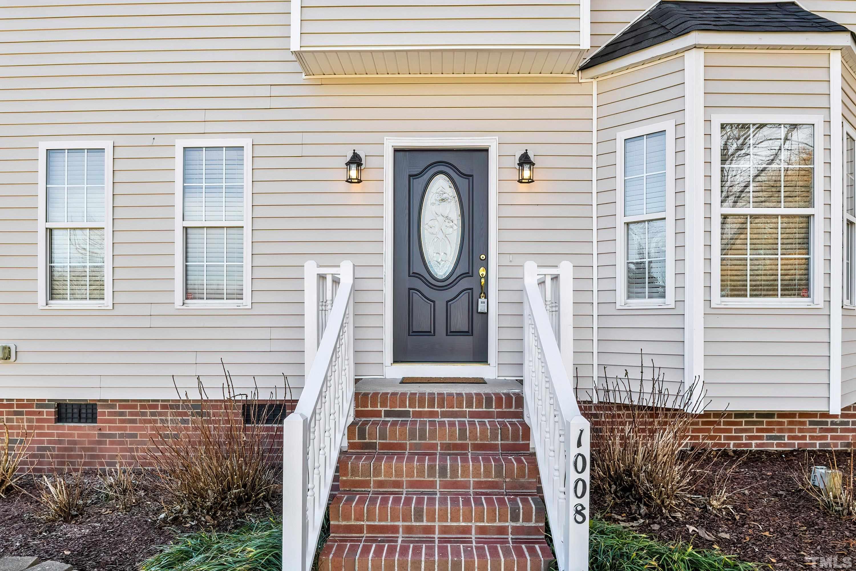 1008 Linden Crest Road Raleigh, NC 27603 - Photo 4 of 37 a front view of a house with a garden