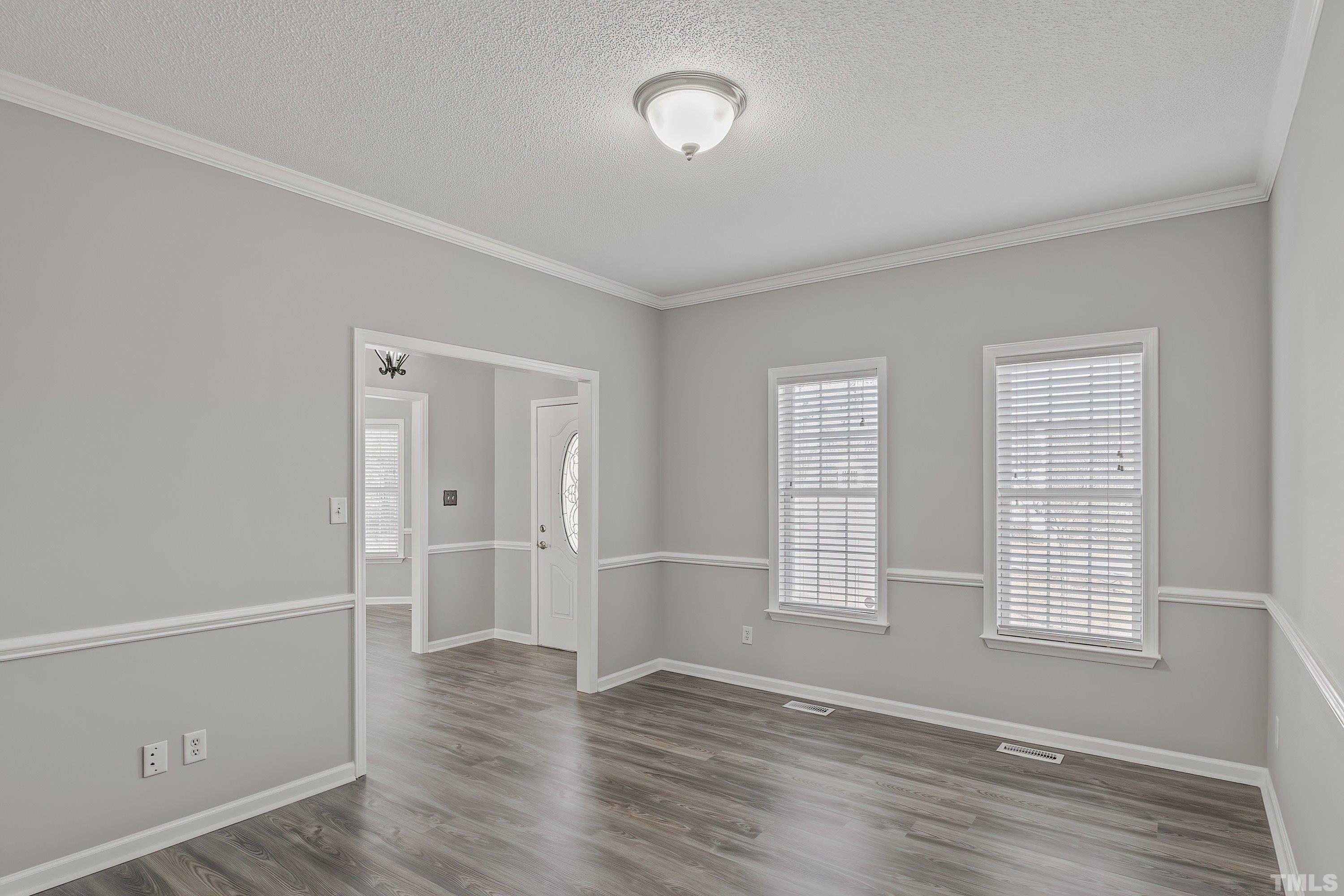 1008 Linden Crest Road Raleigh, NC 27603 - Photo 8 of 37 an empty room with wooden floor and windows