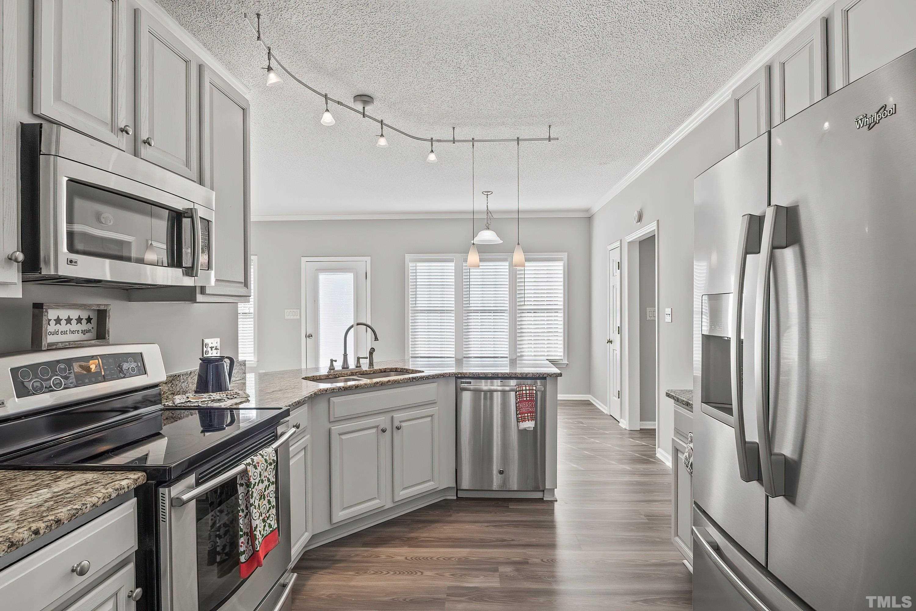 1008 Linden Crest Road Raleigh, NC 27603 - Photo 9 of 37 a kitchen with stainless steel appliances granite countertop a stove a sink dishwasher a refrigerator and a microwave