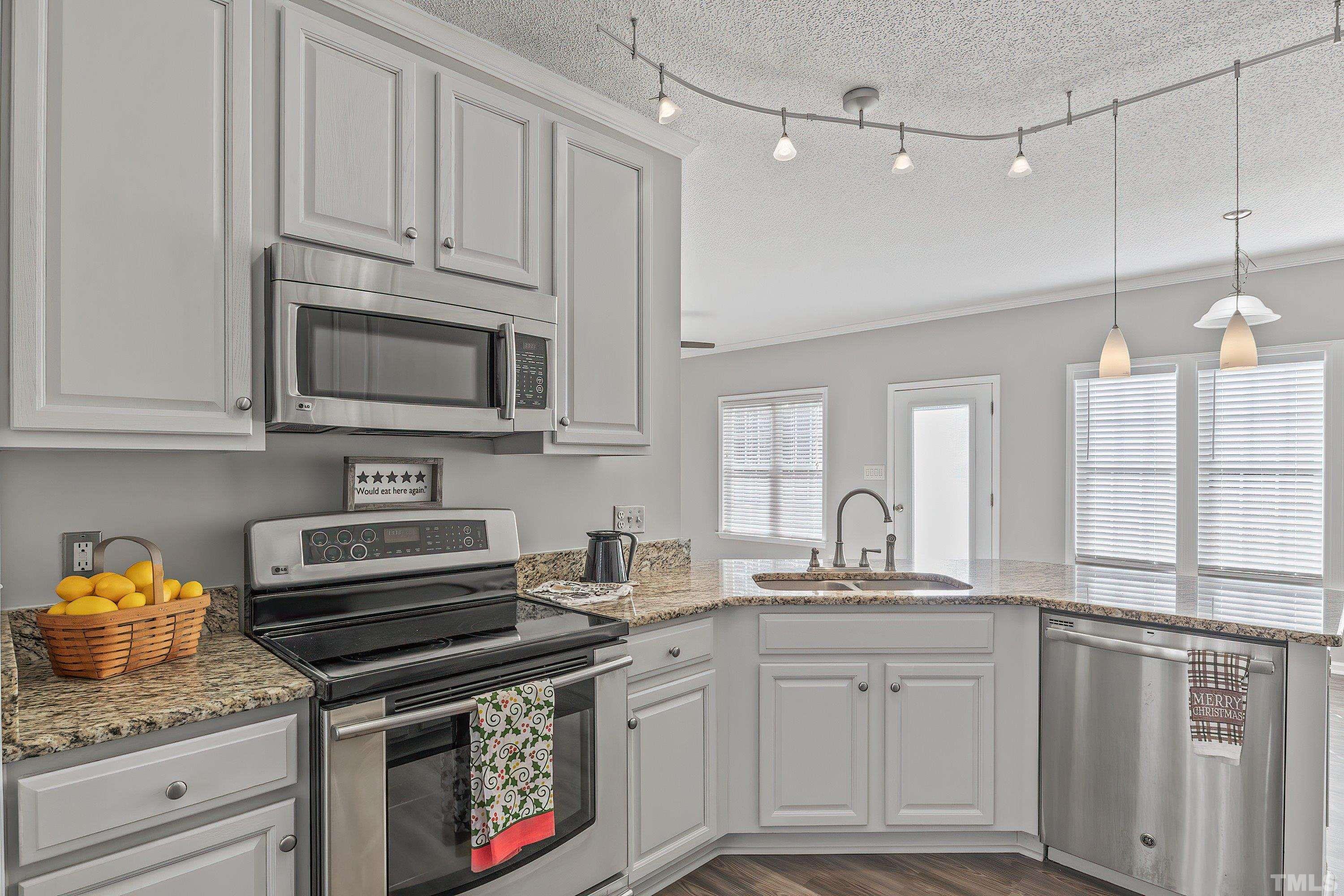 1008 Linden Crest Road Raleigh, NC 27603 - Photo 10 of 37 a kitchen with granite countertop a stove sink and cabinets