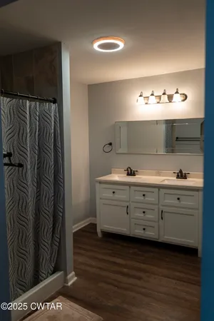 a bathroom with a double vanity sink and mirror