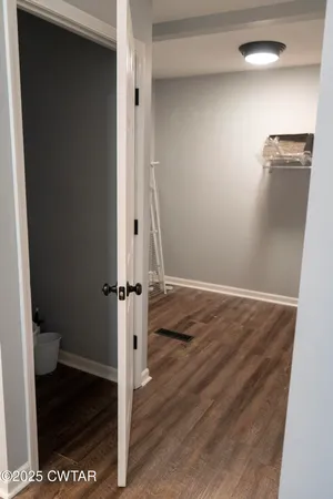 a view of a room with wooden floor
