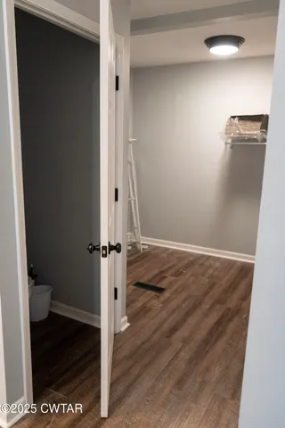 a view of a room with wooden floor