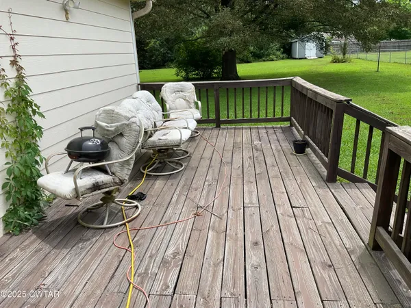 a view of balcony with wooden floor