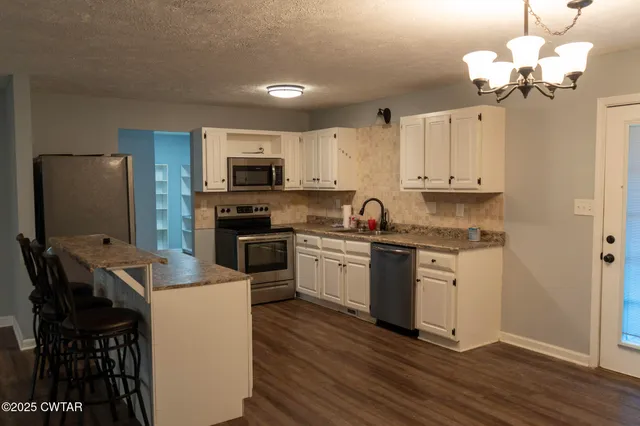 a kitchen with a sink stove and refrigerator
