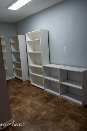 a view of an empty room with empty shelves