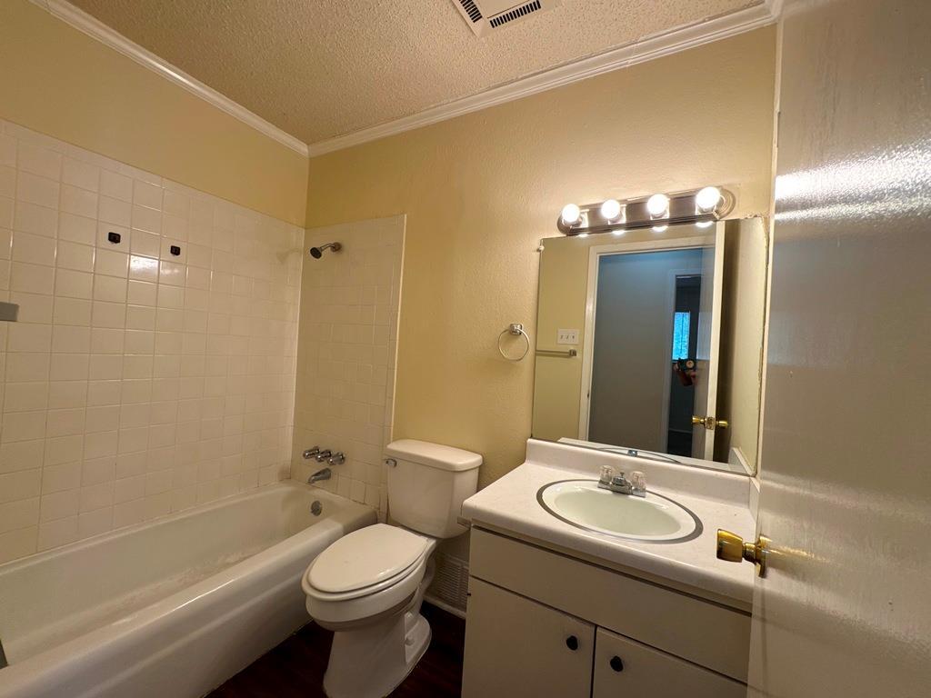 5905 Burrough Drive Austin, TX 78745 - Photo 32 of 40 a bathroom with a toilet sink and mirror