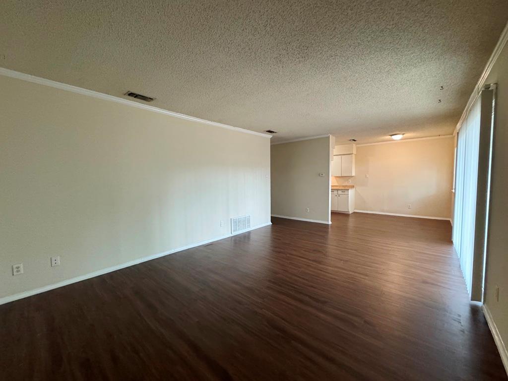 5905 Burrough Drive Austin, TX 78745 - Photo 10 of 40 an empty room with wooden floor and windows