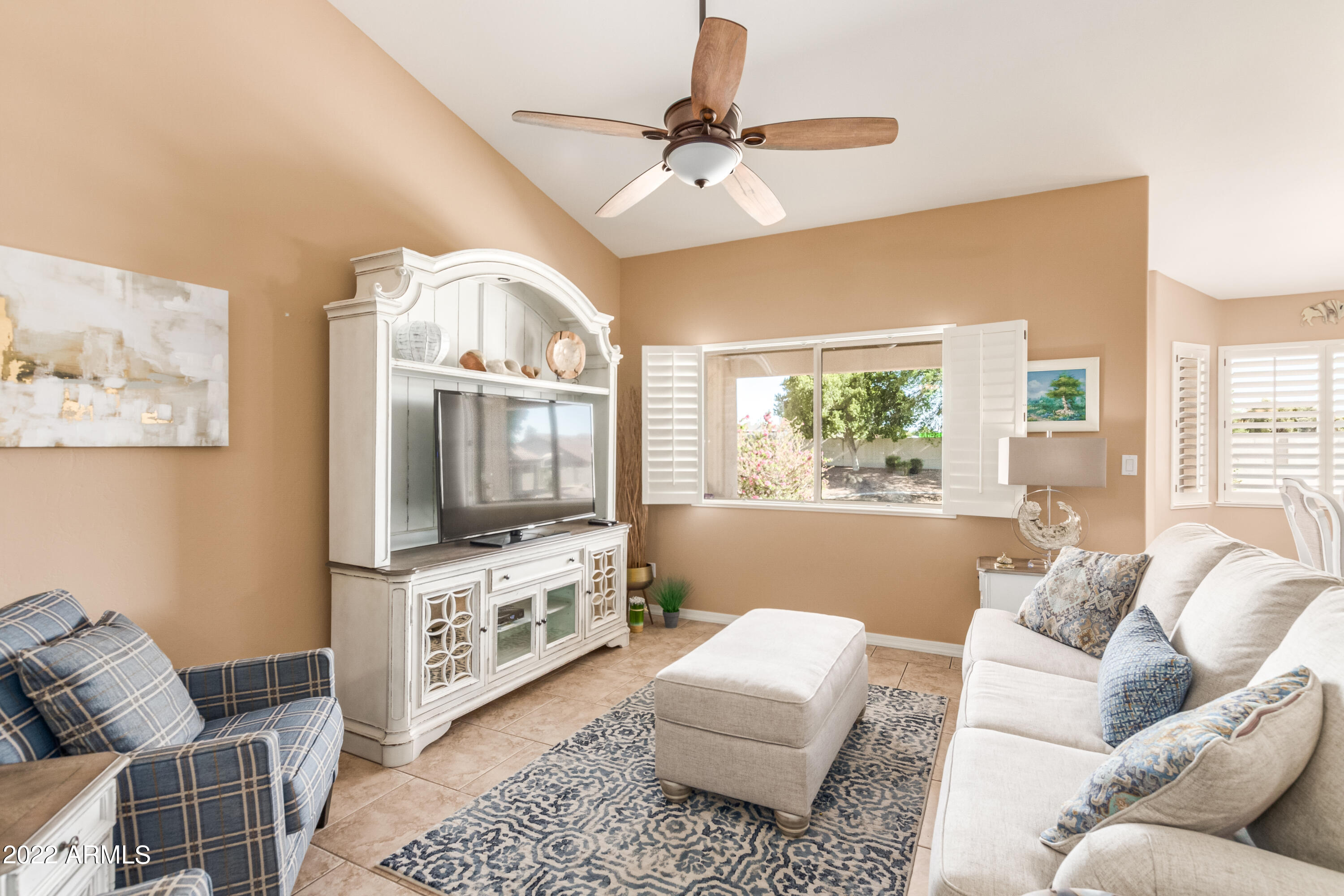 5830 East McKellips Road, Unit 76 Mesa, AZ 85215 - Photo 16 of 33 a living room with furniture and a flat screen tv
