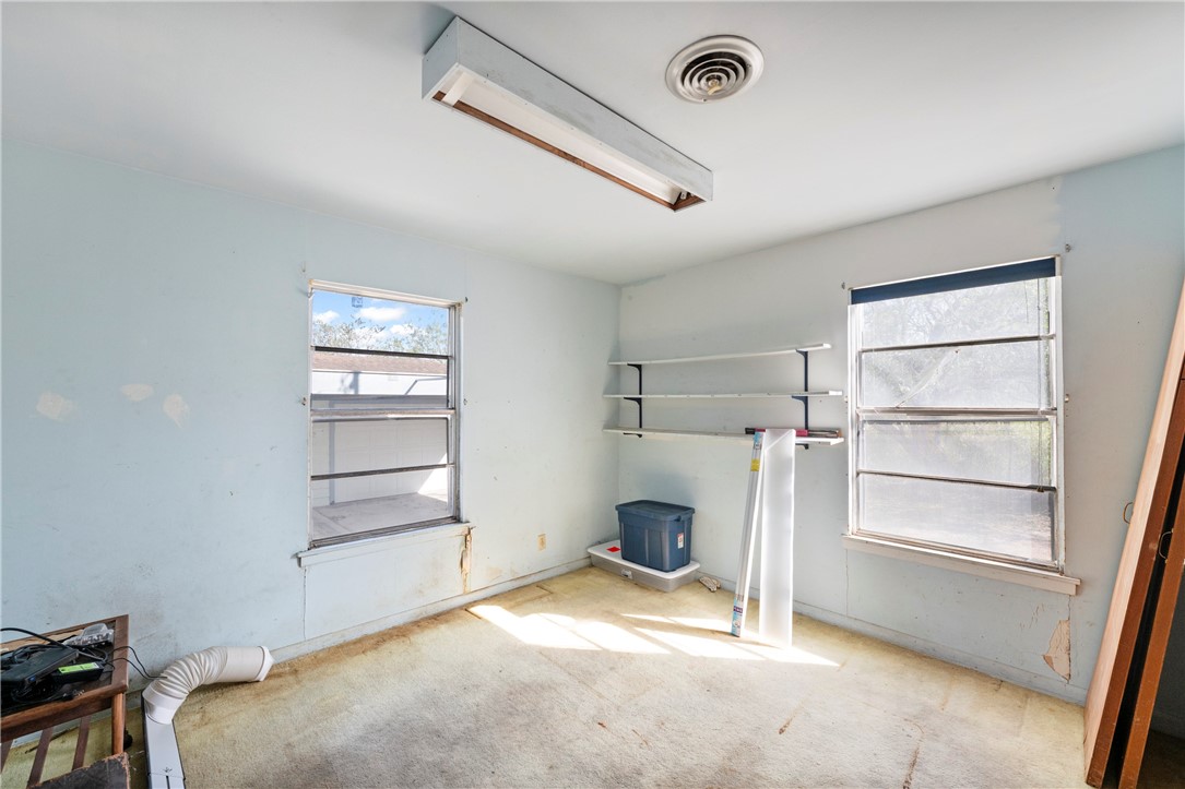 12844 Hearn Road Corpus Christi, TX 78410 - Photo 21 of 34 a room with a bed and a window
