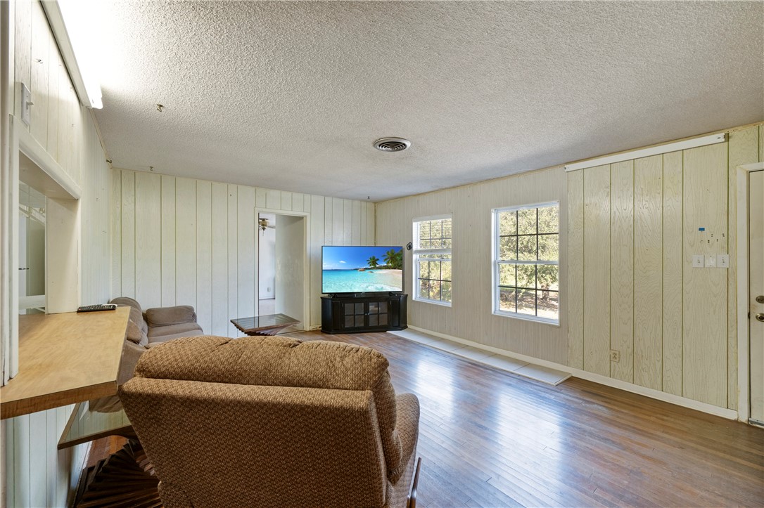 12844 Hearn Road Corpus Christi, TX 78410 - Photo 26 of 34 a living room with furniture a fireplace and a flat screen tv