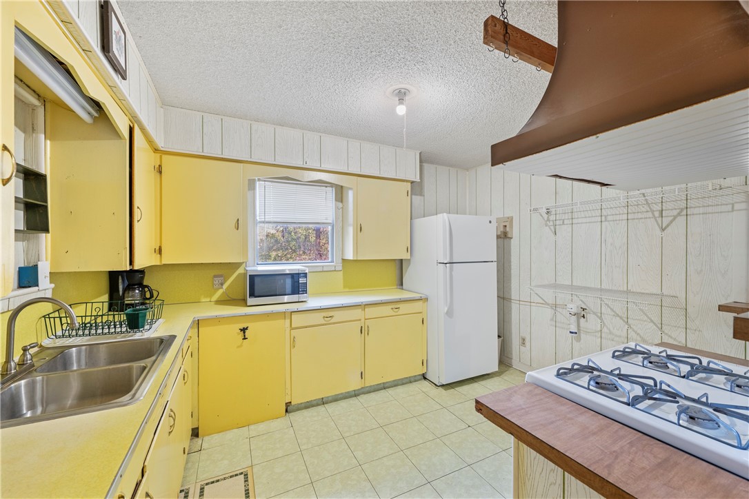 12844 Hearn Road Corpus Christi, TX 78410 - Photo 8 of 34 a kitchen with a sink a stove and refrigerator
