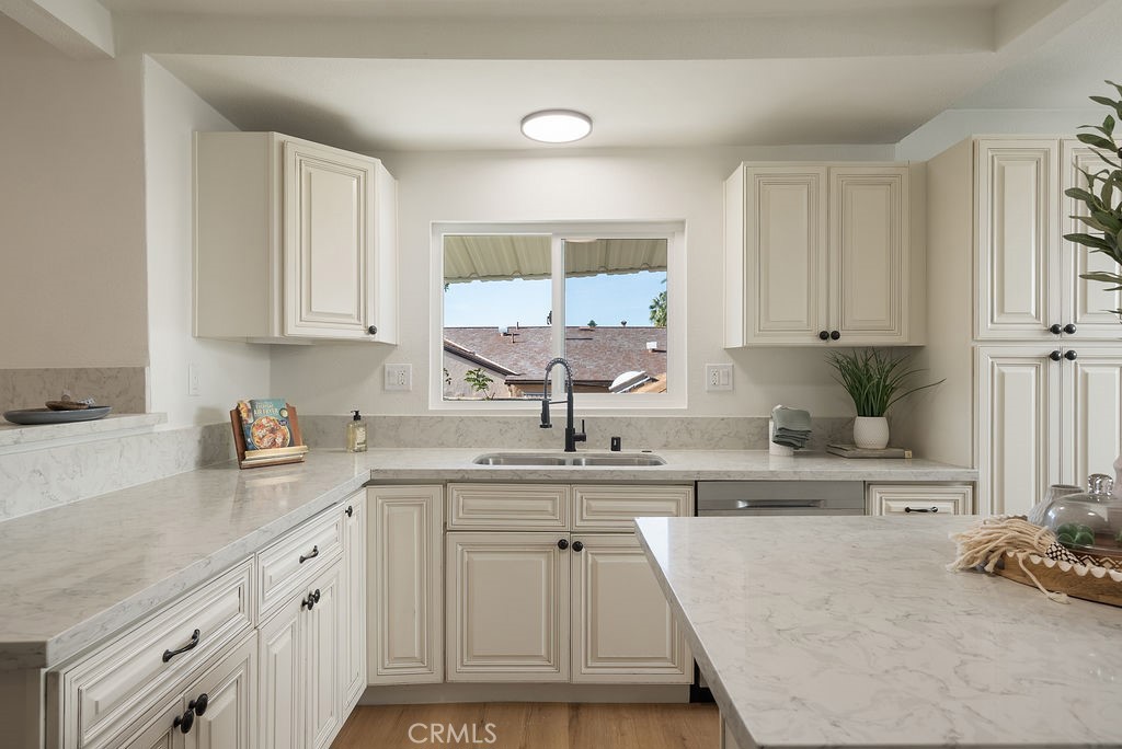 5139 San Rafael Avenue Los Angeles, CA 90042 - Photo 13 of 60 a kitchen with kitchen island granite countertop a sink a stove and cabinets