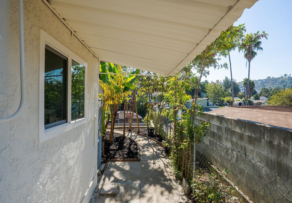 5139 San Rafael Avenue Los Angeles, CA 90042 - Photo 39 of 60 a view of a patio with table and chairs potted plants with floor to ceiling window