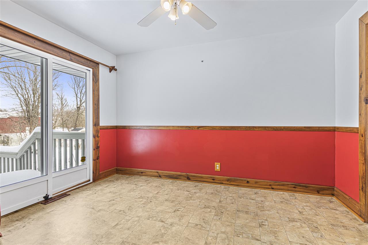 4064 Valerie Road Roscoe, IL 61073 - Photo 8 of 38 an empty room with chandelier fan and windows
