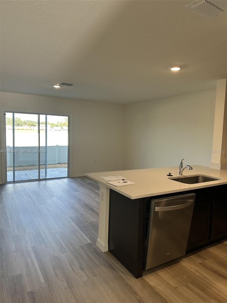 8196 Southwest 67th Avenue Ocala, FL 34476 - Photo 11 of 13 a view of a room with wooden floor and sink