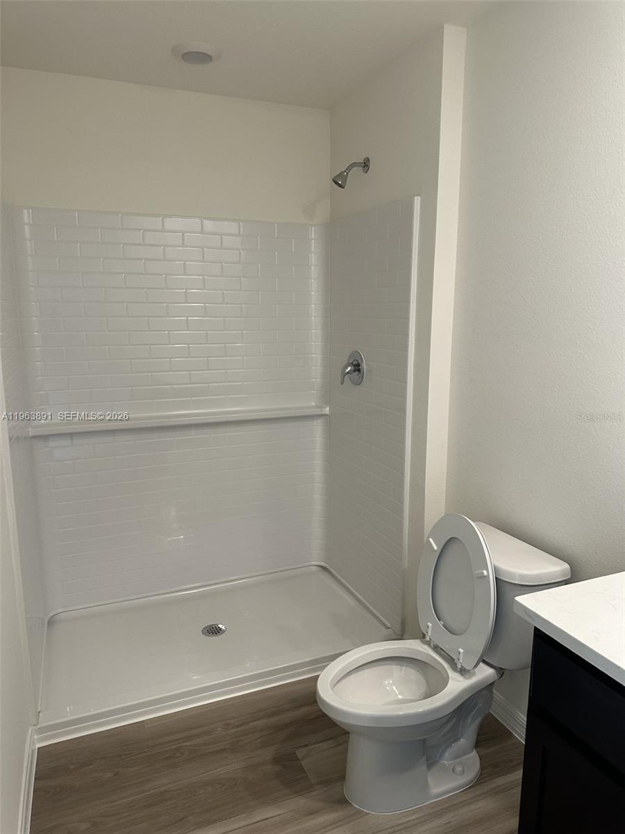 8196 Southwest 67th Avenue Ocala, FL 34476 - Photo 12 of 13 a bathroom with a granite countertop toilet and a sink