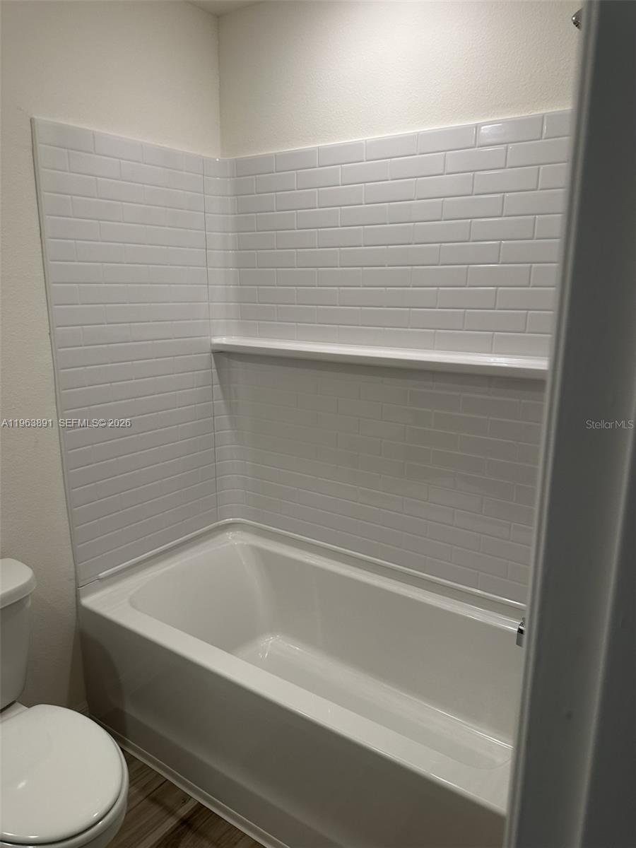8196 Southwest 67th Avenue Ocala, FL 34476 - Photo 3 of 13 a bathroom with a bathtub and toilet