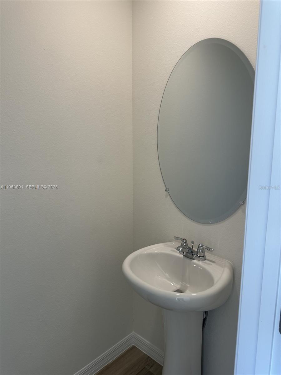 8196 Southwest 67th Avenue Ocala, FL 34476 - Photo 5 of 13 a bathroom with a sink and mirror