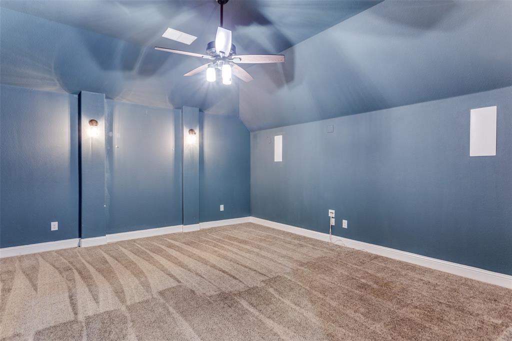 1505 5th Street Argyle, TX 76226 - Photo 19 of 25 a view of an empty room with a chandelier fan
