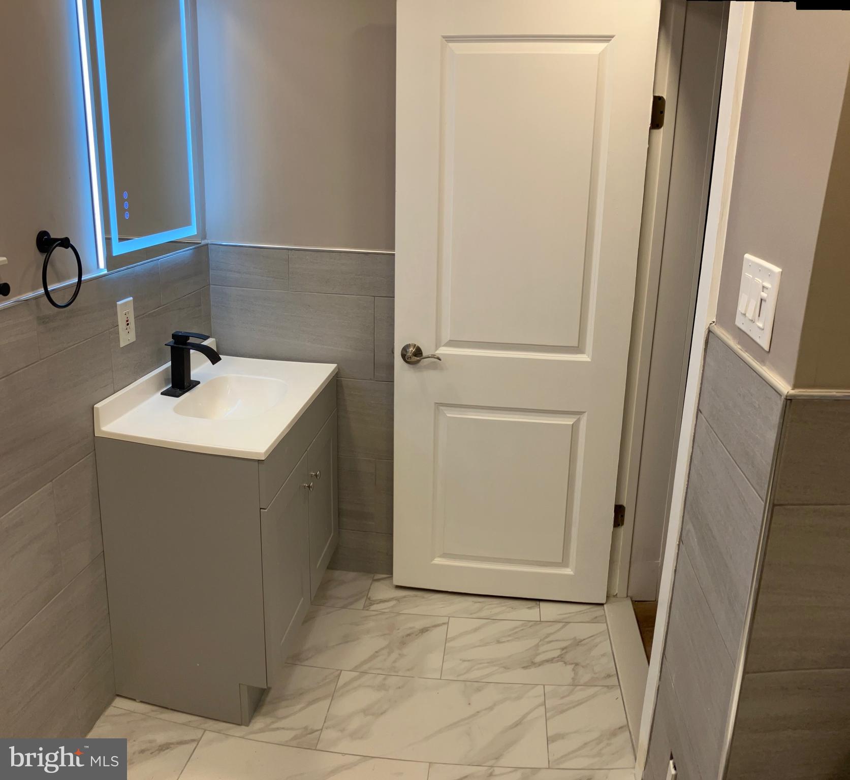 2625 Manton Street Philadelphia, PA 19146 - Photo 13 of 25 a bathroom with a sink a toilet and a mirror