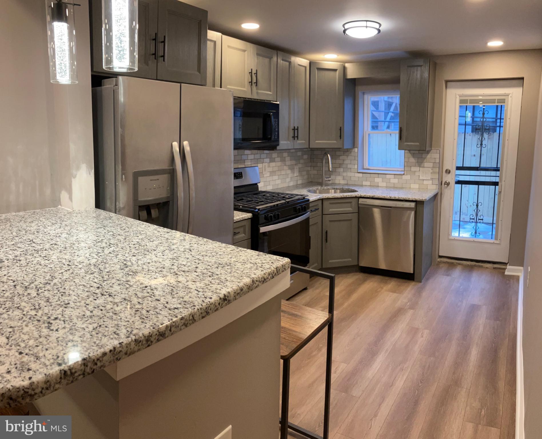 2625 Manton Street Philadelphia, PA 19146 - Photo 2 of 25 a kitchen with stainless steel appliances granite countertop a refrigerator sink and stove