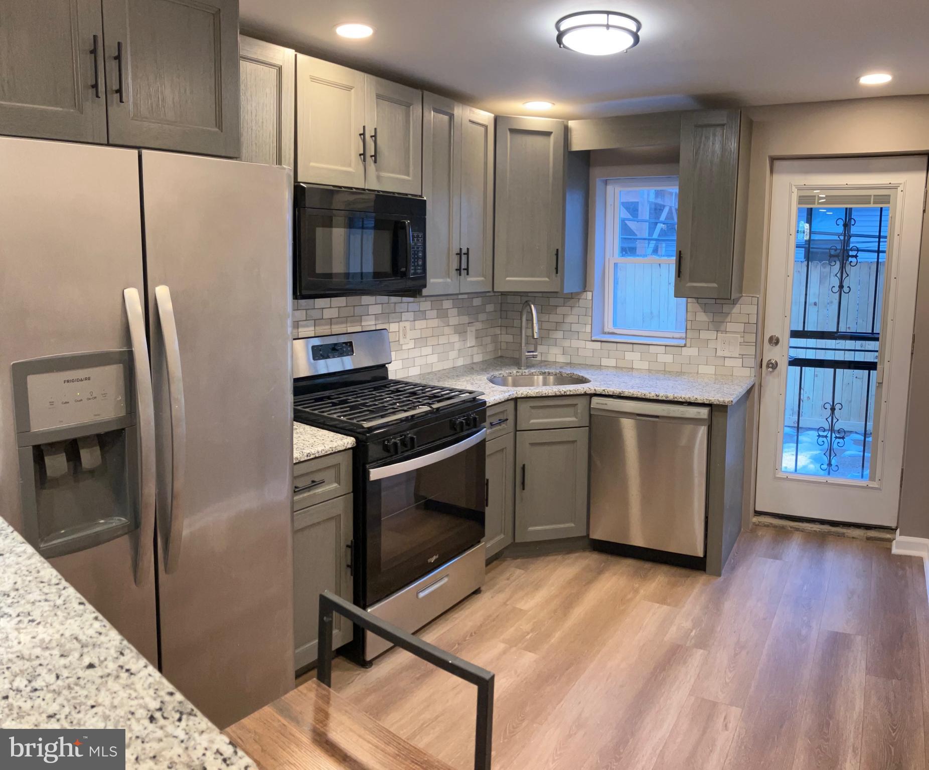 2625 Manton Street Philadelphia, PA 19146 - Photo 3 of 25 a kitchen with stainless steel appliances a stove a sink cabinets and a refrigerator