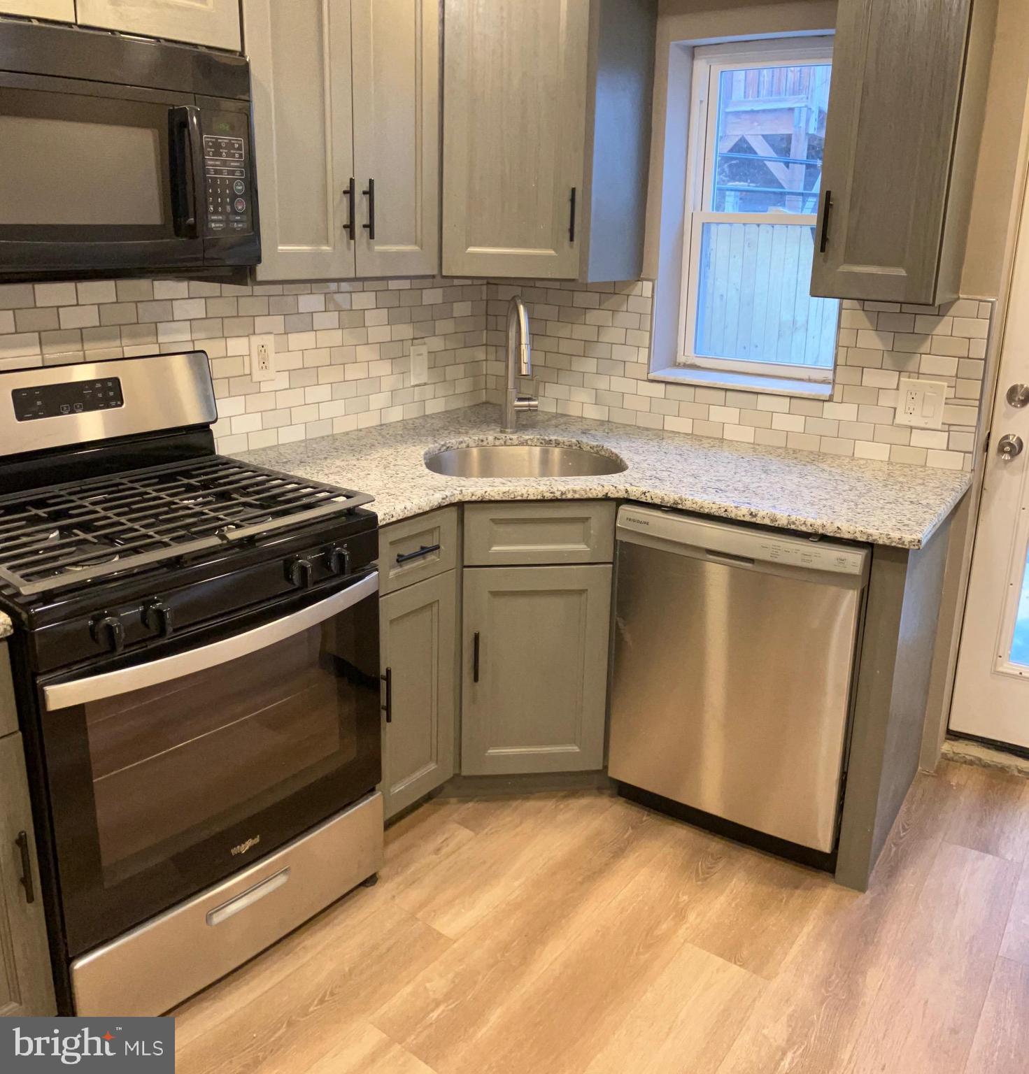 2625 Manton Street Philadelphia, PA 19146 - Photo 5 of 25 a kitchen with stainless steel appliances granite countertop a stove microwave and sink