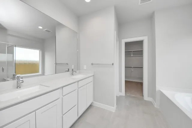 a bathroom with a bathtub and a sink