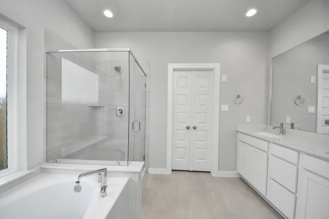 a bathroom with a double vanity sink and mirror